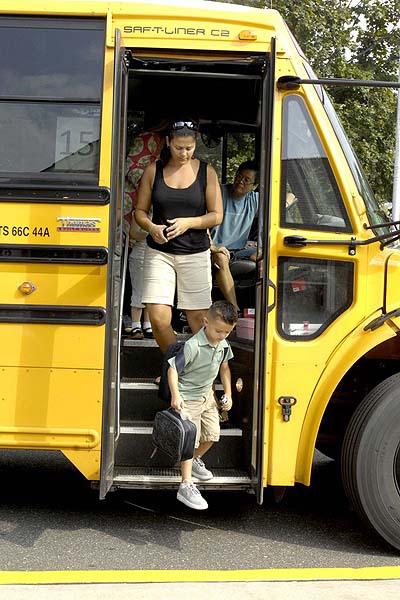 Sara Kent gets off the school bus with her son Noah for his first day of pre-K at Southampton Elementary School on Wednesday.   DANA SHAW