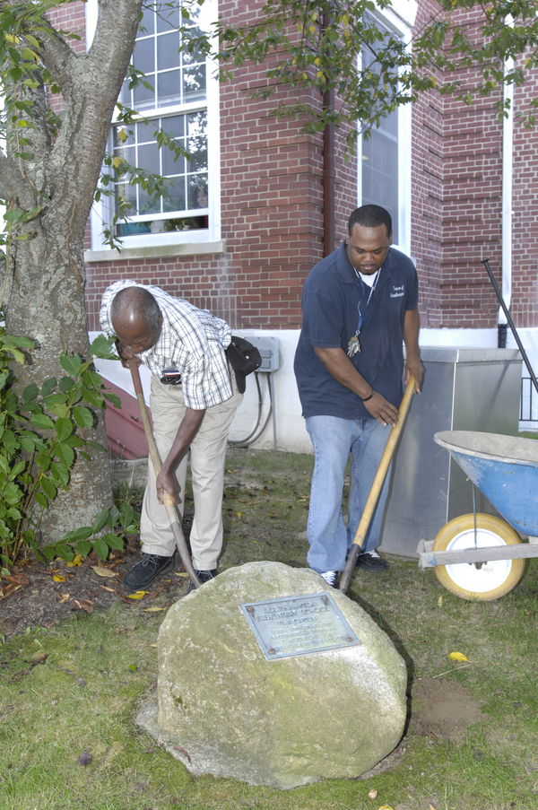 Former Southampton Elementary custodian Clarence Pinckney, left, who was present at the time capsule burial, helps dig.  DANA SHAW