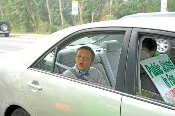 Aiden Killoran drives by suppoters at Westhampton Beach Middle School on Wednesday morning.  DANA SHAW