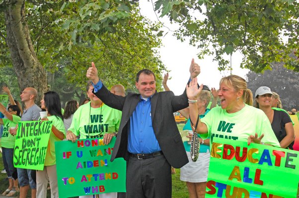 Christian Killoran with  suporters at a protest at Westhampton Beach Middle School on Wednesday morning.  DANA SHAW