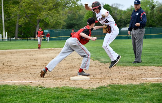 Pierson junior Cooper Schiavoni tries to avoid a tag at third base.