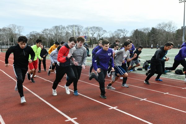 Members of the Hampton Bays boys track team head out on the track for practice on Monday. DANA SHAW