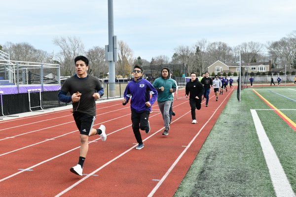 Members of the Hampton Bays boys track team head out on the track for practice on Monday. DANA SHAW