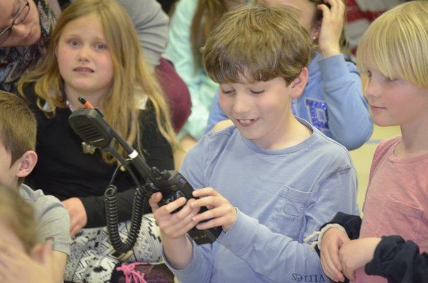 Brayden Pulaski from Remsenburg-Speonk Elementary School uses a walkie-talkie during a demonstration a