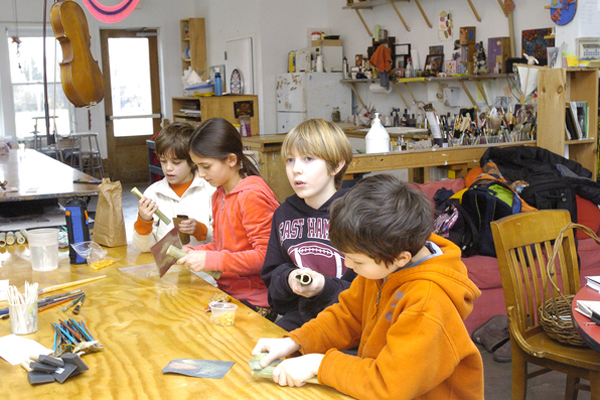 Students work on flutes in Jon Snow’ class at the Hayground School.