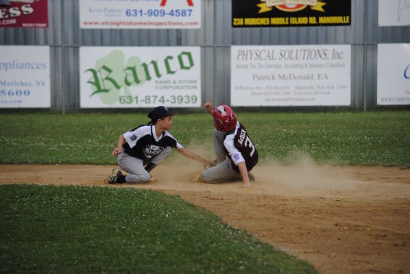 Tyler Hansen slides into second base and beats the tag. DANIELA DETORE