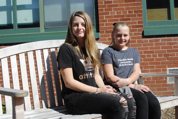 Emily Kyea, left, and her sister Brooke Kyea in the reading garden that was dedicated to their father. AMANDA BERNOCCO