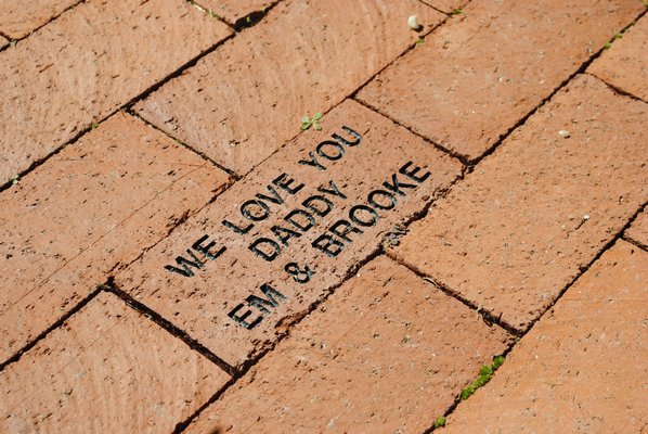Emily and Brooke Kyea dedicated a brick to their father in the East Quogue reading garden. AMANDA BERNOCCO