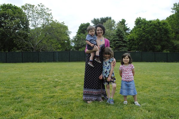 From left: Vanessa Parsons stands with her children William, 1, Emily, 6, and Clara, 3, where the garden would be built. AMANDA BERNOCCO