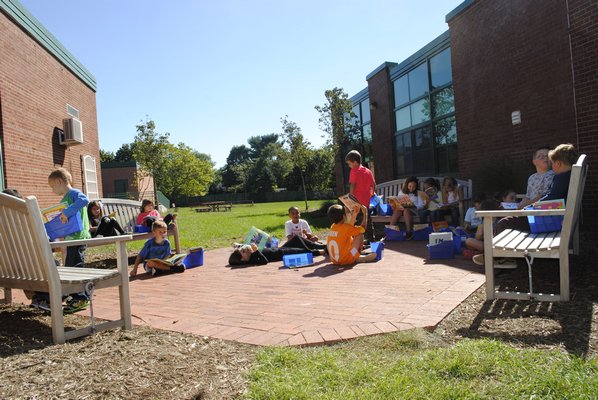 Students enjoy some books in the East Quogue reading garden. AMANDA BERNOCCO