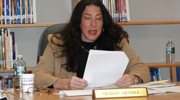 Board chairwoman Sharon Grindle reads a prepared statement announcing the extension of Superintendent-Principal Brian McCarthy's contract.