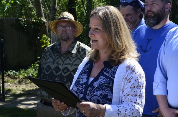 Westhamtpon Beach Village Mayor Maria Moore reads a proclamation at the Westhampton Beach Arbor Day tree planting on Friday. BY ERIN MCKINLEY