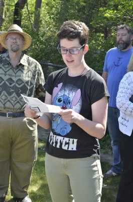 Jackie DeVito, Vice President of the CURE club, reads a poem at the Westhampton Beach Arbor Day tree planting on Friday. BY ERIN MCKINLEY