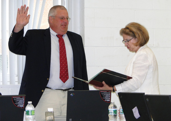 Southampton School District Clerk Mary Pontieri reads the oath of office to School Board Vice President Don King on July 7.