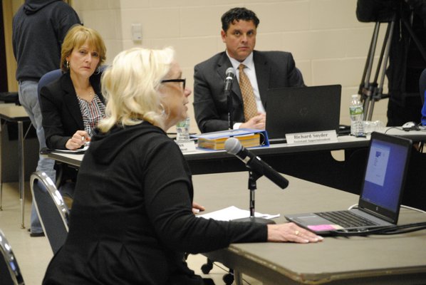 Marion Diener, of Manorville, addresses the board about Superintendent Mark Nocero's retirement. AMANDA BERNOCCO