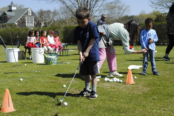 Jacob Berry, a pre-kindergarten student, practices golfing at the Quogue Field Club. AMANDA BERNOCCO