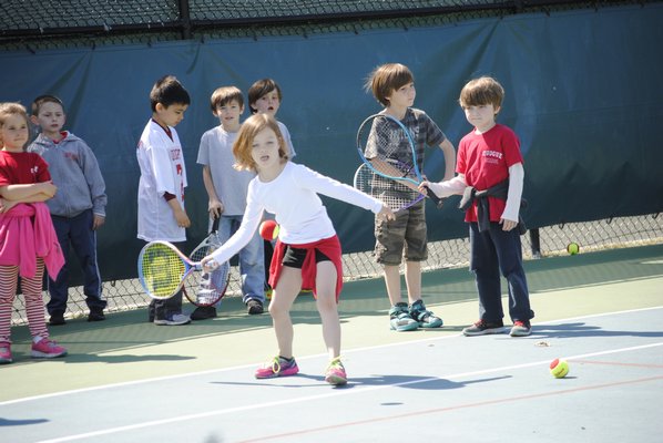 Reagan Schindler, a first grader, practices tennis at the Quogue Field Club. AMANDA BERNOCCO