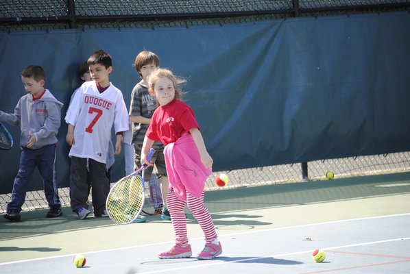 Elizabeth Moore, a first grader, practices tennis at the Quogue Field Club. AMANDA BERNOCCO