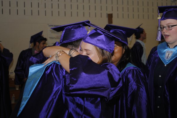 Amelia Salvatore embraces Nicholas Kolb during graduation on Saturday afternoon. AMANDA BERNOCCO