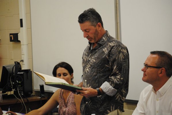 Kevin Springer, vice president of the Hampton Bays Board of Education, is sworn back into office. AMANDA BERNOCCO