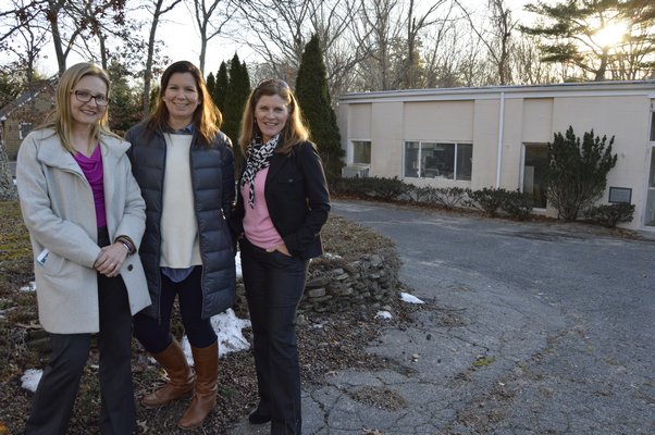 Toni Hoverkamp, left, and Donna Hannigan, members of the Flying Point Foundation for Autism Board of Directors, and foundation President Kim Covell, far right, in front of the building at 1023 Majors Path in North Sea. ALYSSA MELILLO