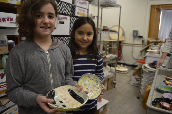 Tuckahoe School third-grade students Olivia Casabianca, left, and Chiara Campaiola display the ceramic bowls they made for the schools second Empty Bowls event, which will be held Thursday evening at the school. The event helps raise awareness of hunger. ALYSSA MELILLO