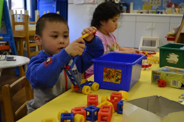 Three-year-old Jason Zhu playing with toys at the Southampton Day Care Center. ANISAH ABDULLAH
