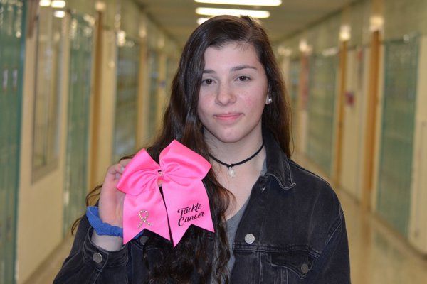 Westhampton Beach High School junior Emily Arpino raised over $4,000 for breast cancer awareness from selling pink cheerleading bows that she made. ANISAH ABDULLAH