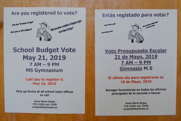 Voter registration flyers in English and Spanish displayed in the Hampton Bays School District centeral administration building. ANISAH ABDULLAH