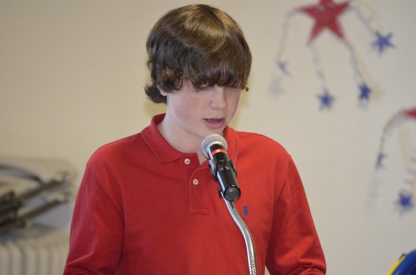 Jackson Marcincuk reads his patriotic speech at a Veteran's Day breakfast at the Tuckahoe School on Monday. BY ERIN MCKINLEY