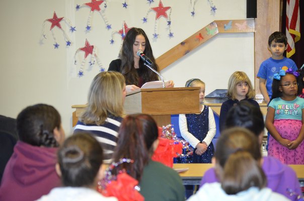Kaitlin Kirshy reads her patriotic speech at a Veteran's Day breakfast at the Tuckahoe School on Monday. BY ERIN MCKINLEY