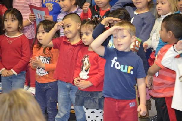 Tuckahoe students salute local veterans on Monday morning during a Veteran's Day breakfast at the Magee Street school. BY ERIN MCKINLEY