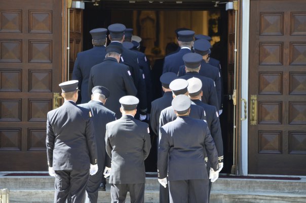Southampton volunteer firefighters enter the church for Edward Corrigan's funeral. ANISAH ABDULLAH