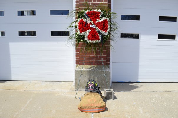 Edward Corrigan's firefighter suit and helmet on display outside of the Southampton Fire Department. ANISAH ABDULLAH