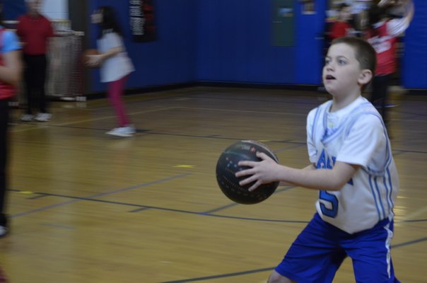 Fifth-grader Chris Koltzan participated in the annual "Hoops for Heart" fundraiser at East Quogue Elementary School on Friday. ALEXA GORMAN