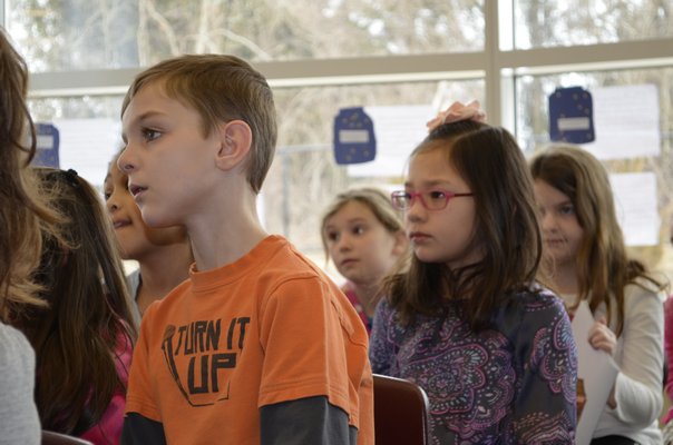 Second-graders Garrett Bollinger and Ellie Herr listen to Patricia Polacco, a children's author and illustrator, speak at Tuttle Avenue School on Friday. ALEXA GORMAN