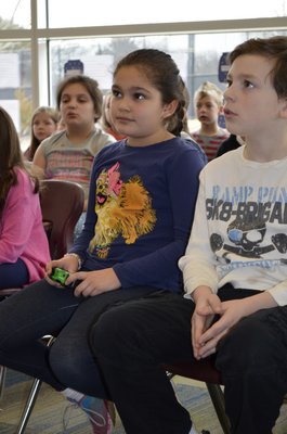 Second-graders Lily Connor and Luke Gagliardi listen to Patricia Polacco, a children's author and illustrator, at Tuttle Avenue School on Friday. ALEXA GORMAN