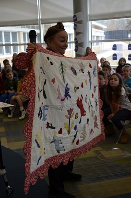 Patricia Polacco, a children's author and illustrator, showed her family quilt at a presentation at Tuttle Avenue School on Friday. ALEXA GORMAN