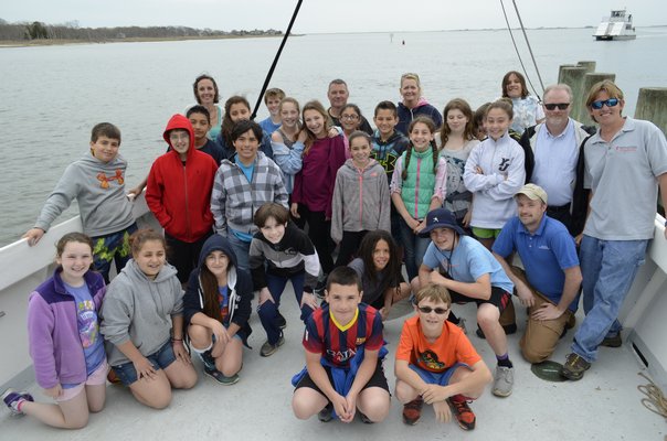 Sixth grade students from East Quogue Elementary School tossed clams into Tiana Bay as part of the Shinnecock Bay Restoration Program. ALEXA GORMAN