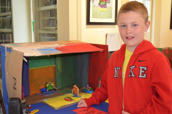 Riley Miller, a Remsenburg-Speonk Elementary School student, displayed his diorama at ArtRemsenburg at The Remsenburg Academy Friday night. ALEXA GORMAN