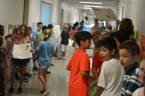 Westhampton Beach Elementary students wait to congratulate graduating seniors from the high school. BY ERIN MCKINLEY