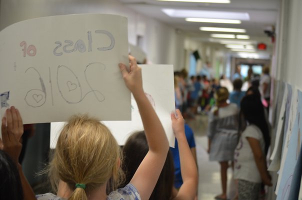 Westhampton Beach Elementary students wait to congratulate graduating seniors from the high school. BY ERIN MCKINLEY