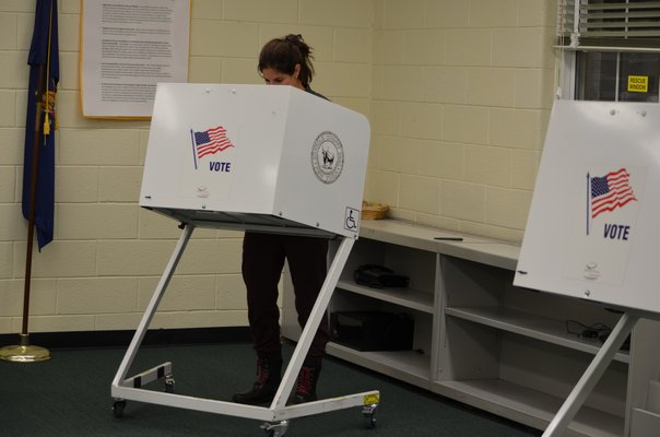 District resident in the voting booth at the Remsenburg-Speonk Elementary School Tuesday night. ANISAH ABDULLAH