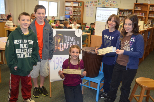 Fifth-graders, left to right, Steven Baltar, Chris Daleo, Isabelle Smith, Davon Marotta and Gasmine Agme with the time capsule found in the elementary school basement. ERIN MCKINLEY