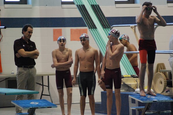 East Hampton/Pierson/Bridgehampton coach Craig Brierley gives some pointers to his swimmers prior to the start of the League II Championships on Thursday, February 2. DREW BUDD