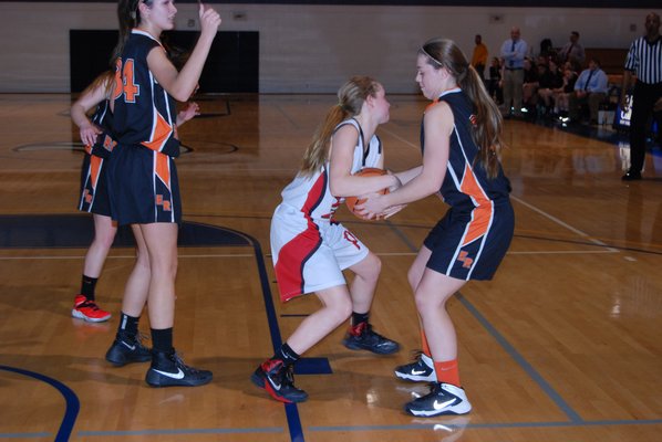 Pierson junior Lily Kot and an East Rockaway player tie up for a jump ball. DREW BUDD