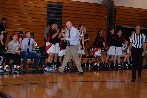 Pierson head coach Kevin Barron and the bench are all fired up after Lily Kot made an awkward layup and was fouled on the play. DREW BUDD