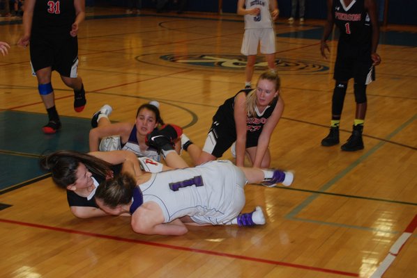 Pierson sophomore Katie Kneeland and Port Jeff's Jackie Brown both grab a loose ball forcing a jump ball. DREW BUDD