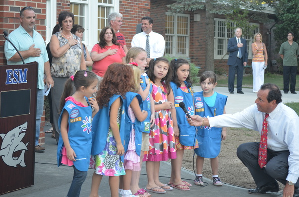 Local Girl Scouts lead the Pledge of Allegiance at the ribbon cutting ceremony last week. ERIN MCKINLEY