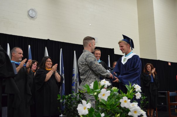 Jacob Black, ESM graduate, received his diploma from his brother, Robert, who has not been home from his time serving in the Air Force in more than one year. Alexa Gorman